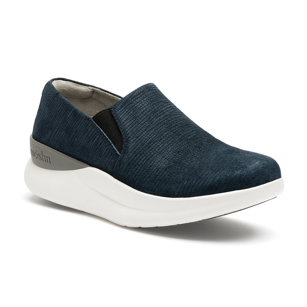 A pair of navy blue suede slip-on shoes with a white sole.