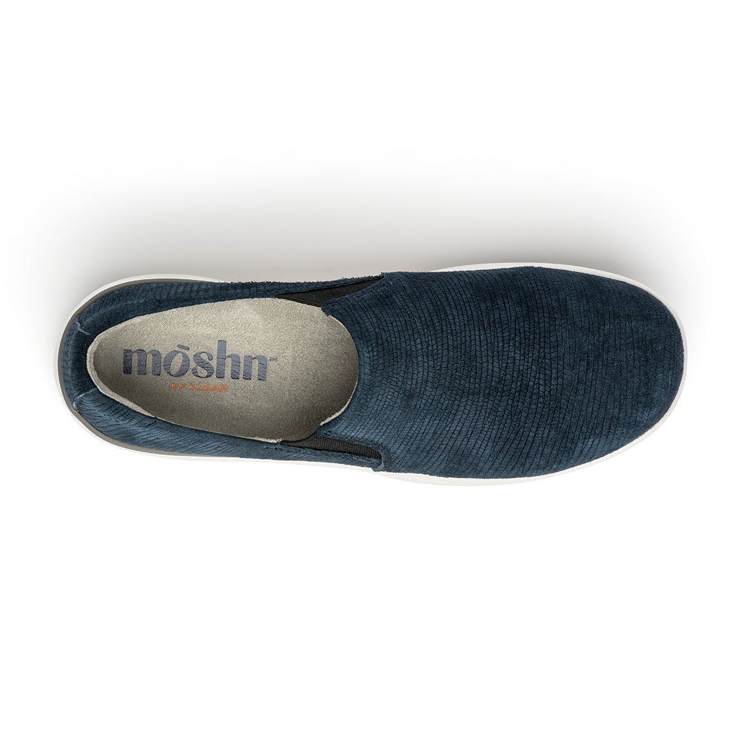 A pair of navy blue suede slip-on shoes with a white sole.
